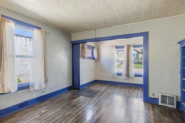 202 6th Ave, Bovey, MN 55709 - unfurnished room featuring wood finished floors, healthy amount of natural light, and baseboards