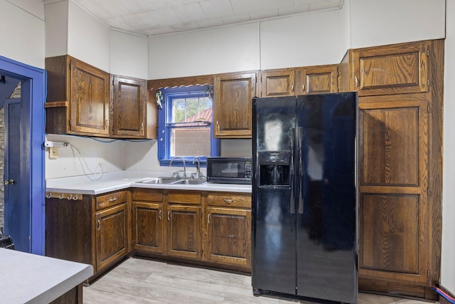 202 6th Ave, Bovey, MN 55709 - kitchen featuring black appliances, a sink, light countertops, and light wood finished floors