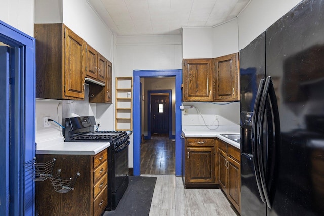 202 6th Ave, Bovey, MN 55709 - kitchen featuring black appliances, light countertops, and light wood finished floors