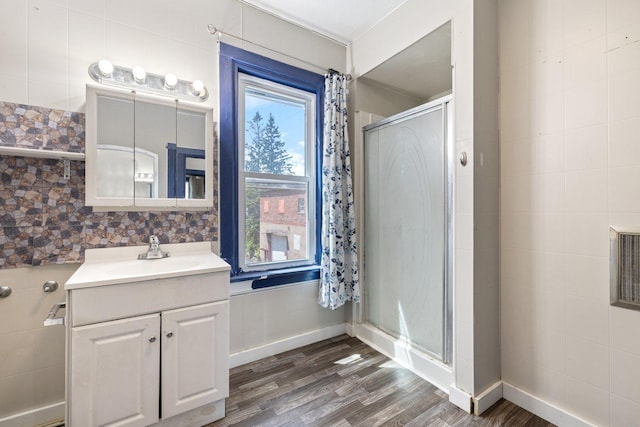202 6th Ave, Bovey, MN 55709 - full bath featuring wood finished floors, vanity, and a stall shower
