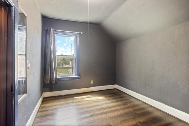 202 6th Ave, Bovey, MN 55709 - additional living space featuring lofted ceiling, wood finished floors, and baseboards