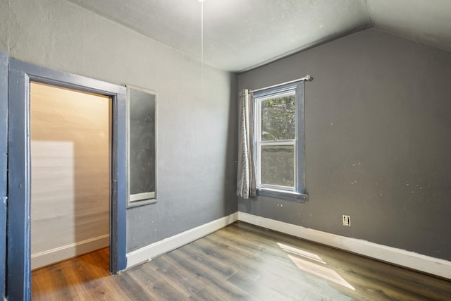 202 6th Ave, Bovey, MN 55709 - unfurnished room with wood finished floors, lofted ceiling, and baseboards