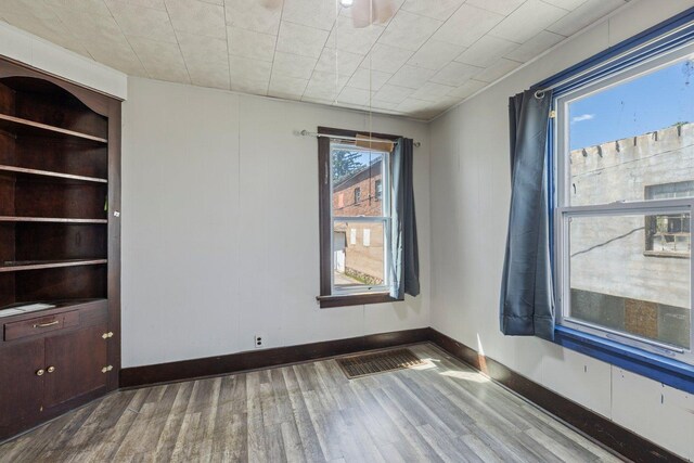 202 6th Ave, Bovey, MN 55709 - empty room with wood finished floors and baseboards