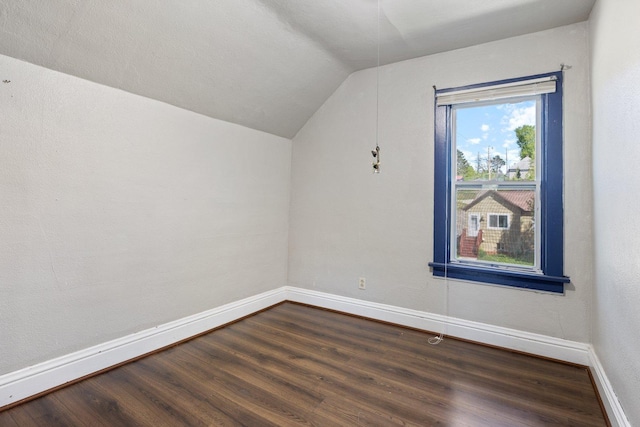 202 6th Ave, Bovey, MN 55709 - bonus room featuring vaulted ceiling, dark wood-style floors, and baseboards