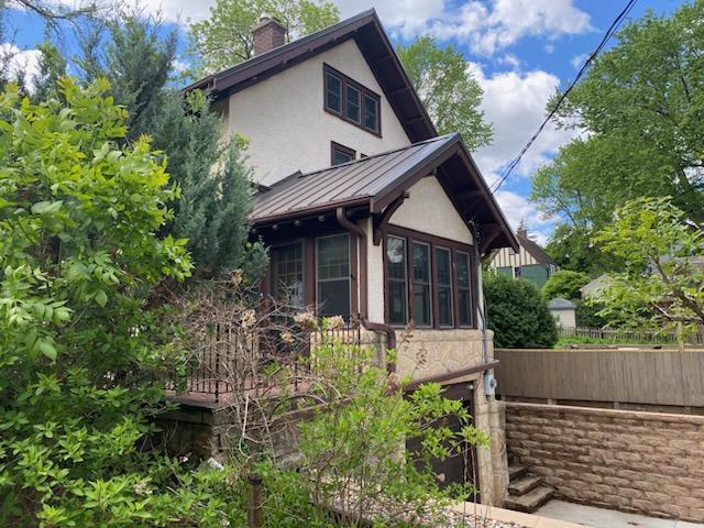 503 14th Ave SW, Rochester, MN 55902 - view of side of property featuring a standing seam roof, stucco siding, a chimney, and metal roof
