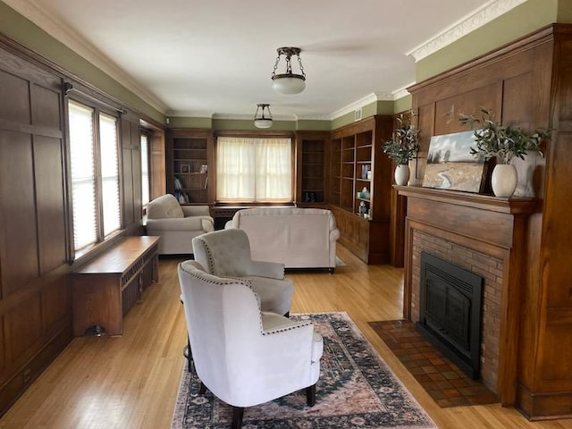 503 14th Ave SW, Rochester, MN 55902 - living area with light wood-style floors, a brick fireplace, and crown molding