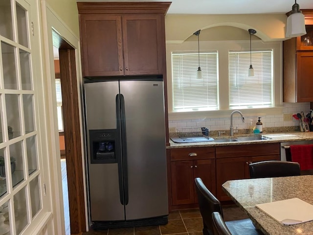 503 14th Ave SW, Rochester, MN 55902 - kitchen with stainless steel refrigerator with ice dispenser, a sink, tasteful backsplash, light stone counters, and pendant lighting
