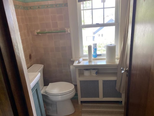 503 14th Ave SW, Rochester, MN 55902 - half bath with toilet, tile patterned flooring, radiator heating unit, and vanity