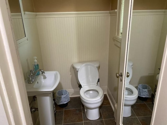 503 14th Ave SW, Rochester, MN 55902 - bathroom featuring toilet, wainscoting, and tile patterned floors