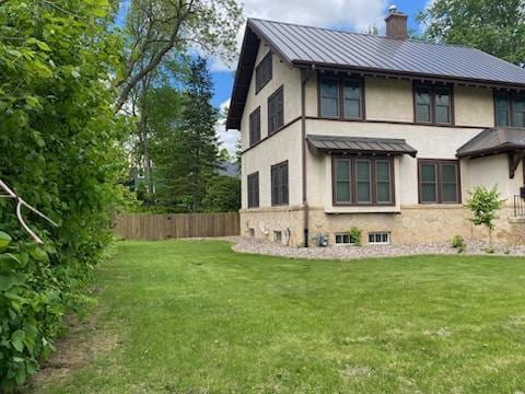 503 14th Ave SW, Rochester, MN 55902 - back of property featuring a standing seam roof, a chimney, stucco siding, and metal roof