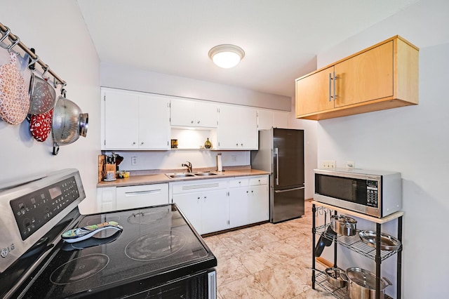 5030 Sheridan Ave S, Minneapolis, MN 55410 - kitchen with appliances with stainless steel finishes, open shelves, white cabinets, and light countertops
