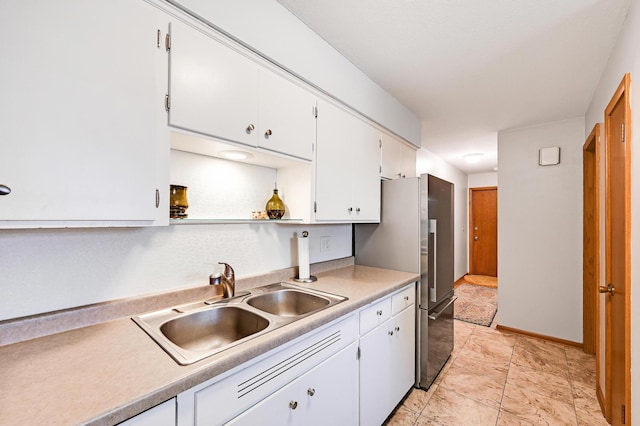 5030 Sheridan Ave S, Minneapolis, MN 55410 - kitchen featuring white cabinetry, light countertops, and freestanding refrigerator