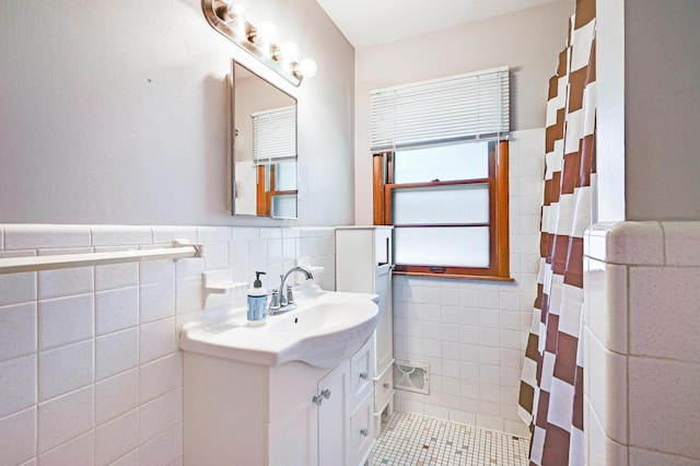 5030 Sheridan Ave S, Minneapolis, MN 55410 - full bathroom featuring tile walls, vanity, tile patterned floors, curtained shower, and a wainscoted wall