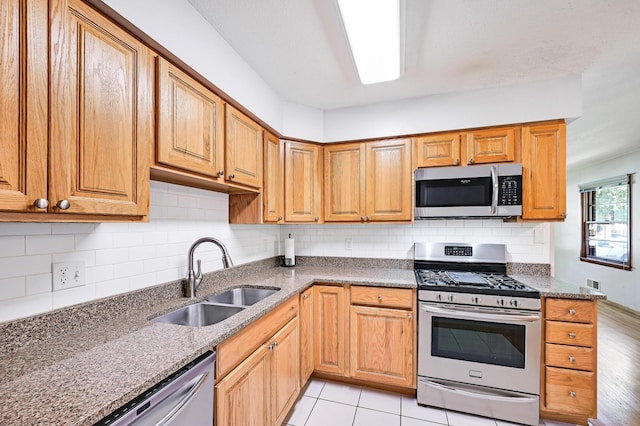 5030 Sheridan Ave S, Minneapolis, MN 55410 - kitchen featuring stainless steel appliances, stone countertops, and decorative backsplash