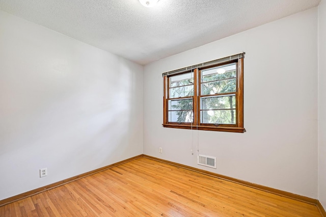 5030 Sheridan Ave S, Minneapolis, MN 55410 - unfurnished room featuring light wood-style flooring and a textured ceiling