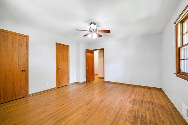 5030 Sheridan Ave S, Minneapolis, MN 55410 - unfurnished bedroom with light wood-style flooring, multiple closets, and a ceiling fan