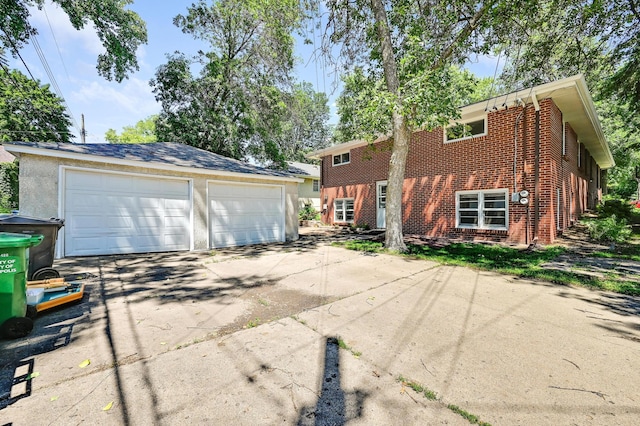 5030 Sheridan Ave S, Minneapolis, MN 55410 - view of home's exterior with brick siding, a detached garage, and an outbuilding