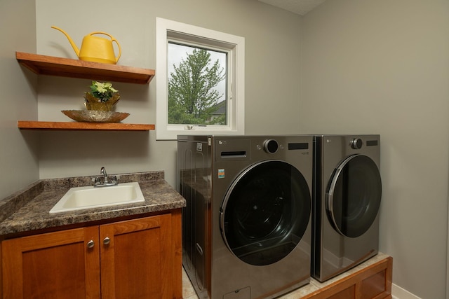 1121 Maplebeck Enclave NE, Byron, MN 55920 - laundry room featuring washer and clothes dryer, cabinet space, and baseboards