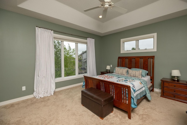1121 Maplebeck Enclave NE, Byron, MN 55920 - bedroom featuring carpet, baseboards, a tray ceiling, and a ceiling fan