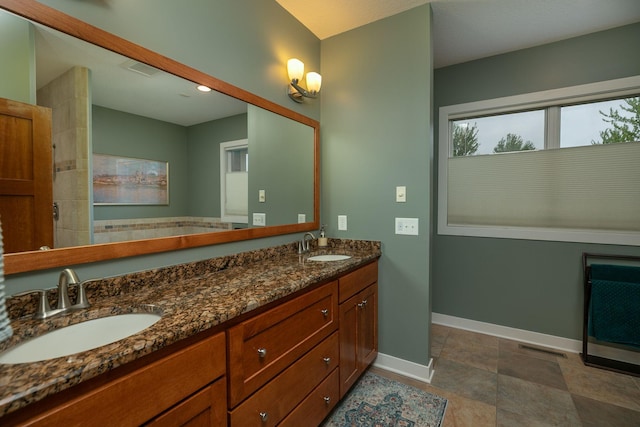 1121 Maplebeck Enclave NE, Byron, MN 55920 - bathroom with double vanity, baseboards, and recessed lighting