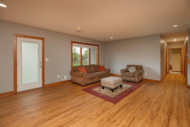 1121 Maplebeck Enclave NE, Byron, MN 55920 - living room featuring light wood-style flooring, baseboards, and recessed lighting