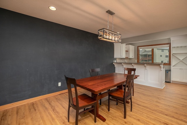 1121 Maplebeck Enclave NE, Byron, MN 55920 - dining space featuring light wood finished floors, baseboards, a chandelier, and recessed lighting