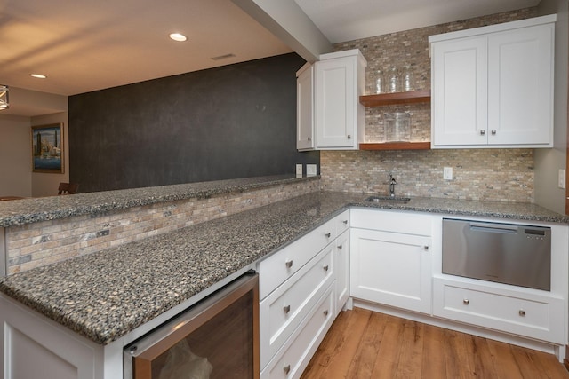 1121 Maplebeck Enclave NE, Byron, MN 55920 - kitchen with wine cooler, open shelves, a peninsula, light wood-style floors, and backsplash