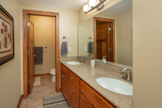 1121 Maplebeck Enclave NE, Byron, MN 55920 - full bath featuring double vanity, toilet, tile patterned flooring, and baseboards