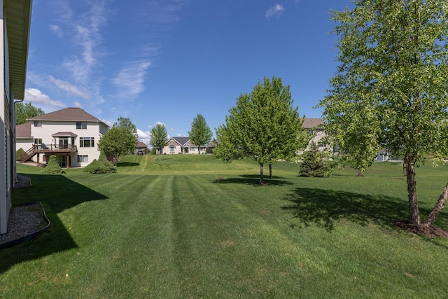 1121 Maplebeck Enclave NE, Byron, MN 55920 - view of green lawn featuring a deck