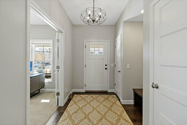 11686 32nd St N, Lake Elmo, MN 55042 - entrance foyer with a chandelier, dark wood-style floors, and baseboards