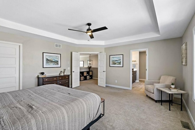 11686 32nd St N, Lake Elmo, MN 55042 - bedroom featuring a tray ceiling, light carpet, baseboards, and ceiling fan
