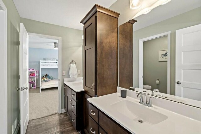 11686 32nd St N, Lake Elmo, MN 55042 - ensuite bathroom with vanity, wood finished floors, and toilet