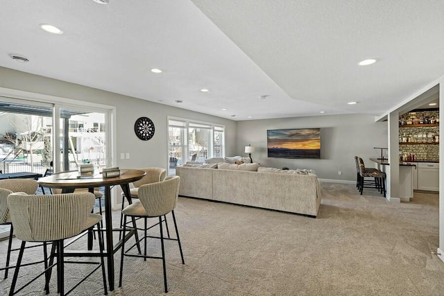 11686 32nd St N, Lake Elmo, MN 55042 - dining room featuring light colored carpet, healthy amount of natural light, recessed lighting, baseboards, and a dry bar