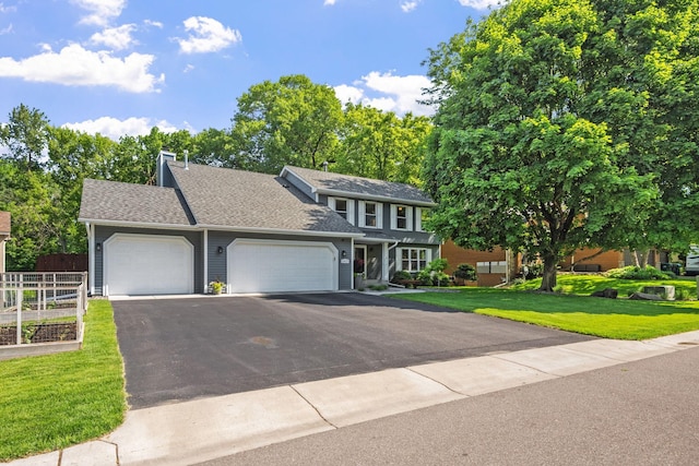 11422 71st Ave N, Maple Grove, MN 55369 - view of front of home featuring a garage, asphalt driveway, a chimney, and roof with shingles