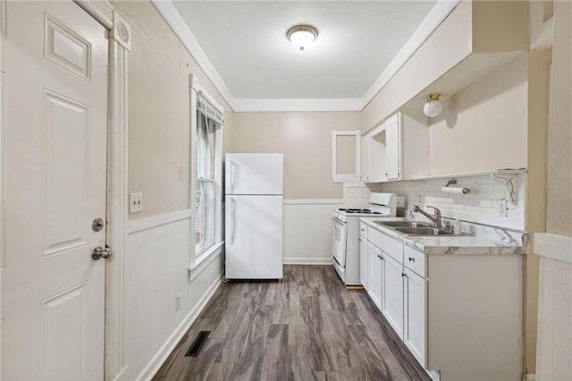 481 Edmund Ave, Saint Paul, MN 55103 - kitchen featuring white appliances, white cabinets, light countertops, a sink, and dark wood-style flooring