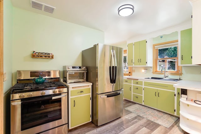 4845 15th Ave S, Minneapolis, MN 55417 - kitchen with appliances with stainless steel finishes, a sink, light wood-type flooring, and light countertops