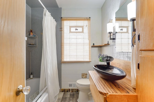 4845 15th Ave S, Minneapolis, MN 55417 - bathroom with wood finished floors, plenty of natural light, toilet, and shower / bath combo