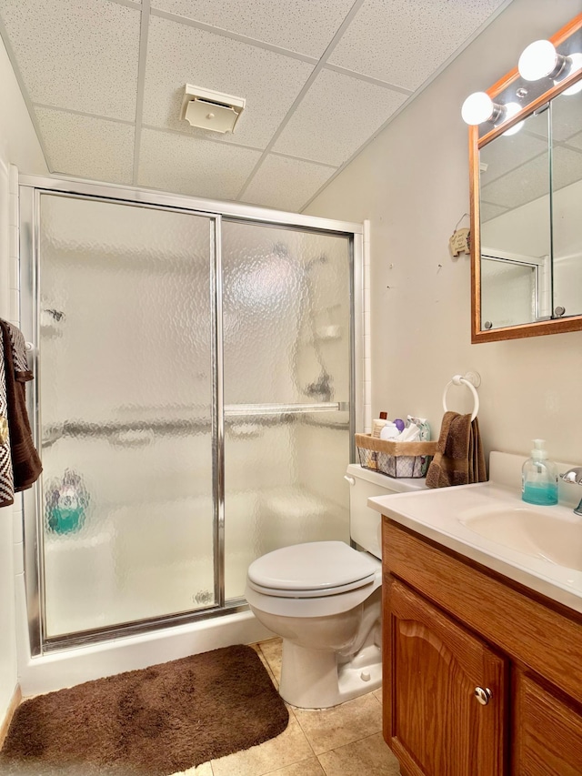 1815 Lakewood Ave, Albert Lea, MN 56007 - full bathroom with vanity, a drop ceiling, a shower stall, toilet, and tile patterned flooring