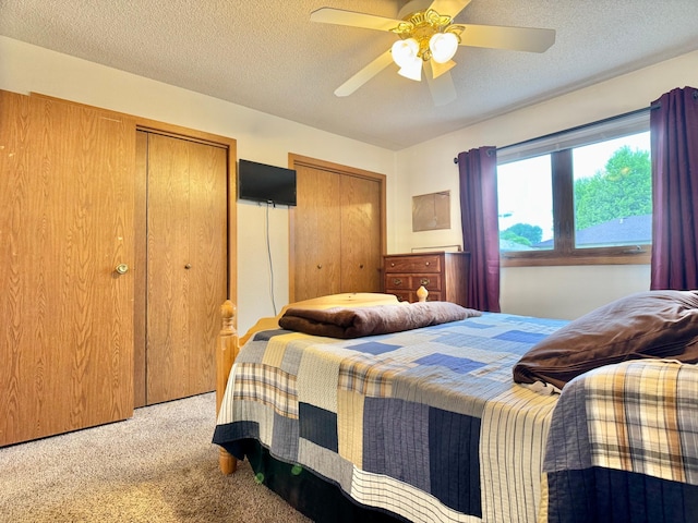 1815 Lakewood Ave, Albert Lea, MN 56007 - bedroom featuring multiple closets, light carpet, a textured ceiling, and a ceiling fan