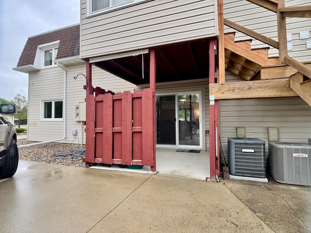 1815 Lakewood Ave, Albert Lea, MN 56007 - doorway to property with central air condition unit, roof with shingles, and mansard roof