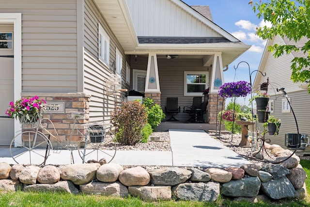 525 Roanoke Ct, Waconia, MN 55387 - entrance to property featuring board and batten siding, covered porch, a shingled roof, and stone siding