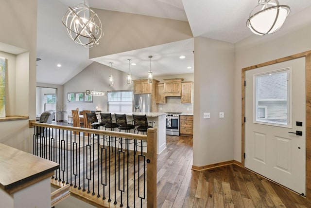 525 Roanoke Ct, Waconia, MN 55387 - kitchen with appliances with stainless steel finishes, lofted ceiling, hardwood / wood-style flooring, light countertops, and baseboards