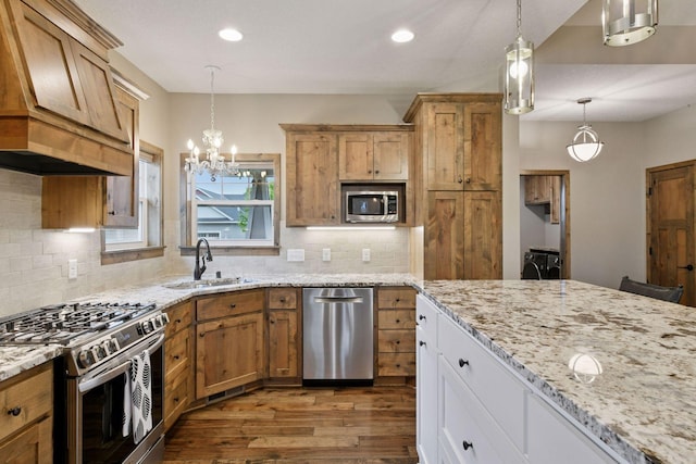 525 Roanoke Ct, Waconia, MN 55387 - kitchen featuring appliances with stainless steel finishes, a sink, dark wood-style flooring, a chandelier, and custom range hood