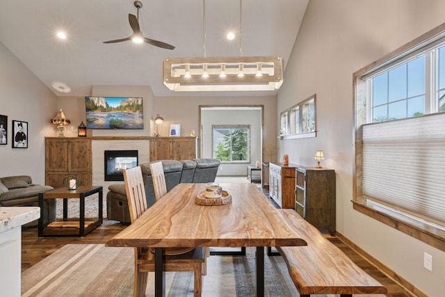 525 Roanoke Ct, Waconia, MN 55387 - dining room with dark wood-type flooring, a ceiling fan, recessed lighting, and a tiled fireplace