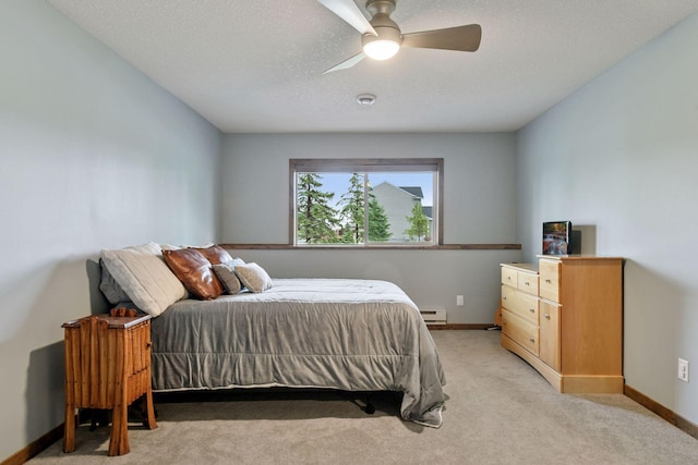 525 Roanoke Ct, Waconia, MN 55387 - bedroom with a baseboard heating unit, light carpet, baseboards, and a ceiling fan