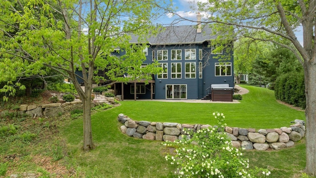 18172 Tamarack Dr, Minnetonka, MN 55345 - back of property featuring a lawn, a chimney, a wooden deck, and a patio