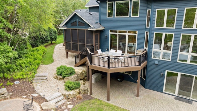 18172 Tamarack Dr, Minnetonka, MN 55345 - back of property with a patio, a shingled roof, a sunroom, a deck, and outdoor dining area