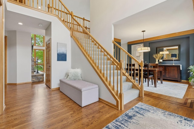 18172 Tamarack Dr, Minnetonka, MN 55345 - stairway with a high ceiling, baseboards, wood finished floors, and recessed lighting