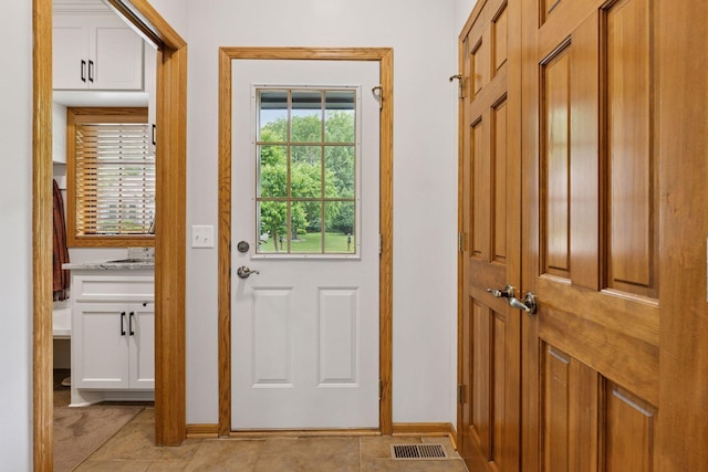 18172 Tamarack Dr, Minnetonka, MN 55345 - entryway with baseboards, light tile patterned flooring, and a sink
