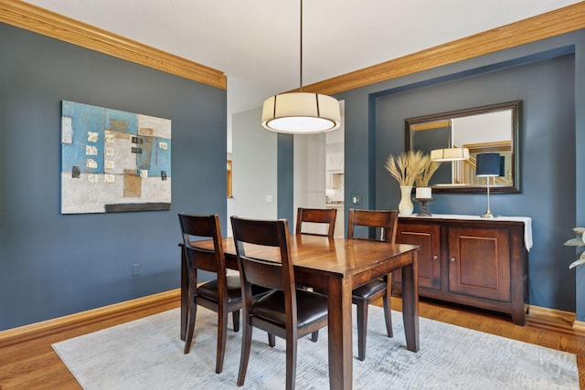 18172 Tamarack Dr, Minnetonka, MN 55345 - dining area featuring wood finished floors, baseboards, and crown molding
